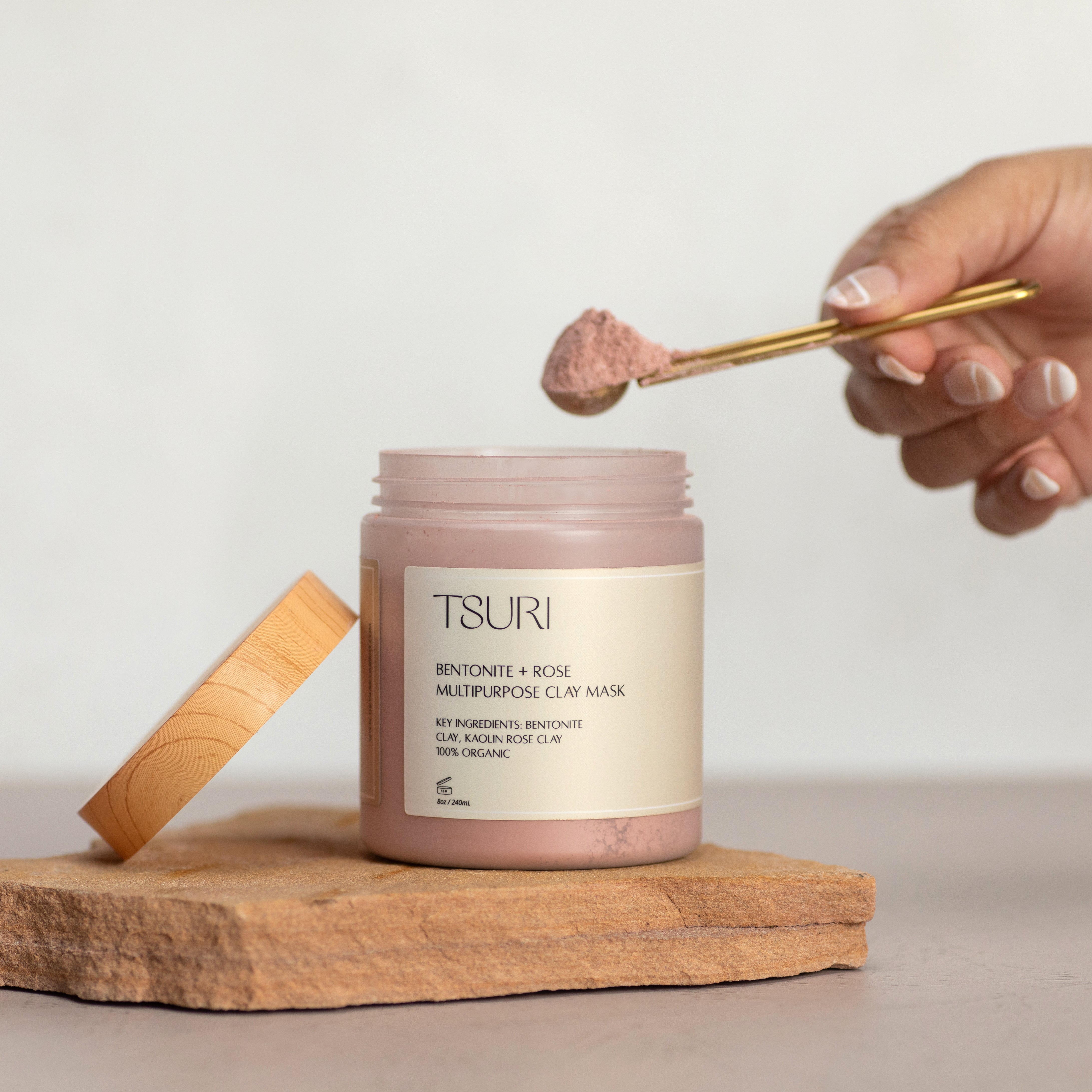 Bentonite + Rose Clay Mask in jar with spoon, detoxifies and revitalizes skin and scalp, infused with rose and lavender oils.