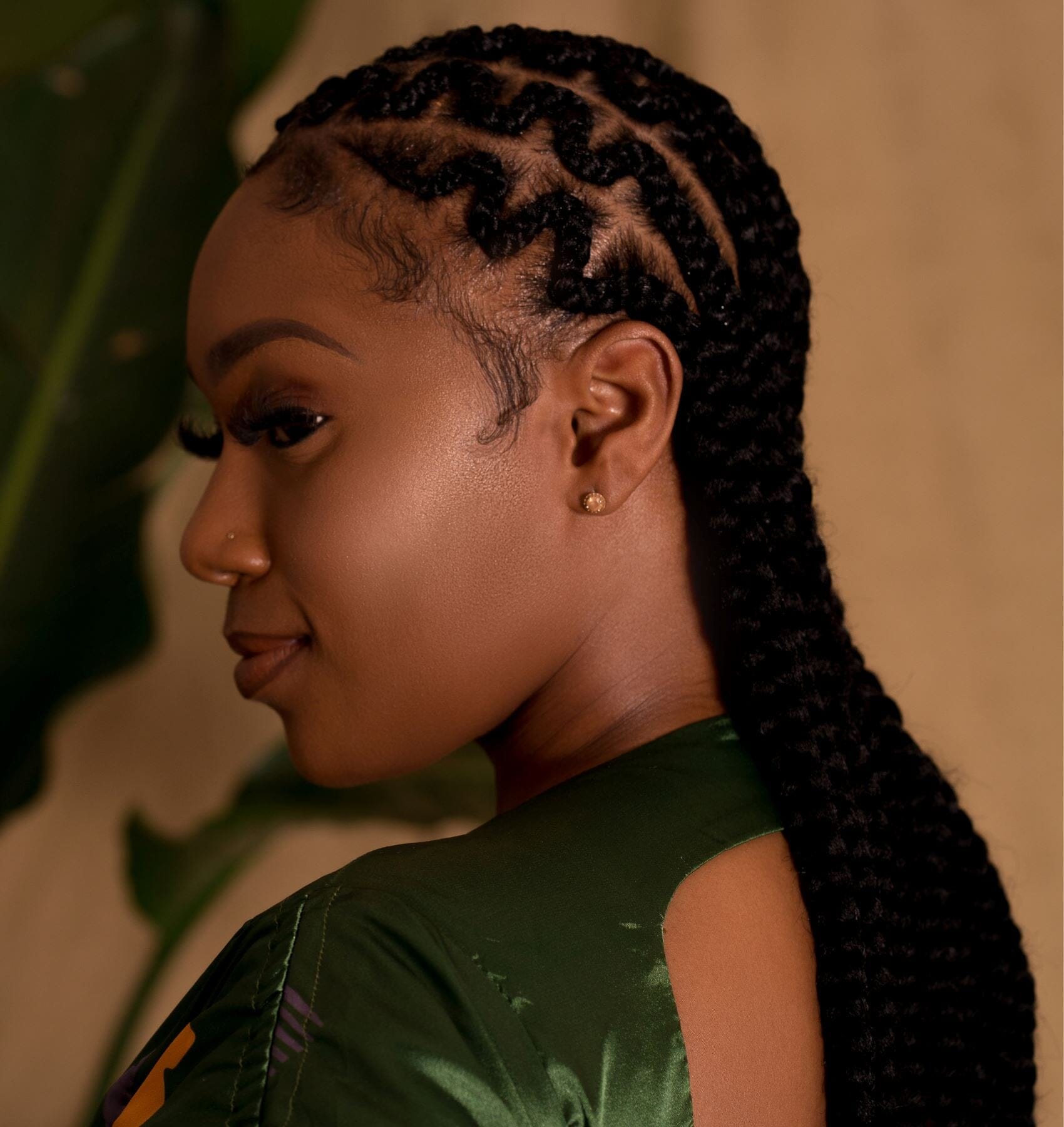 Woman with braids styled using 28" hypoallergenic braiding hair, showcasing protective and irritation-free comfort.