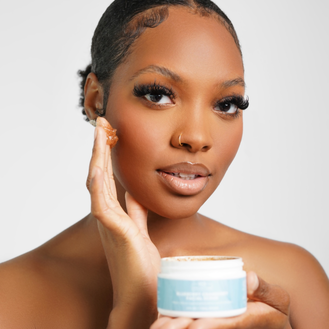 Woman applying vegan blueberry cranberry facial scrub for exfoliating and brightening skin care treatment.