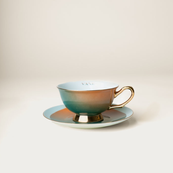 Ombré tea set cup and saucer in haint blue with gold accents, inspired by Gullah-Geechee culture and designed by Lynae Vanee.