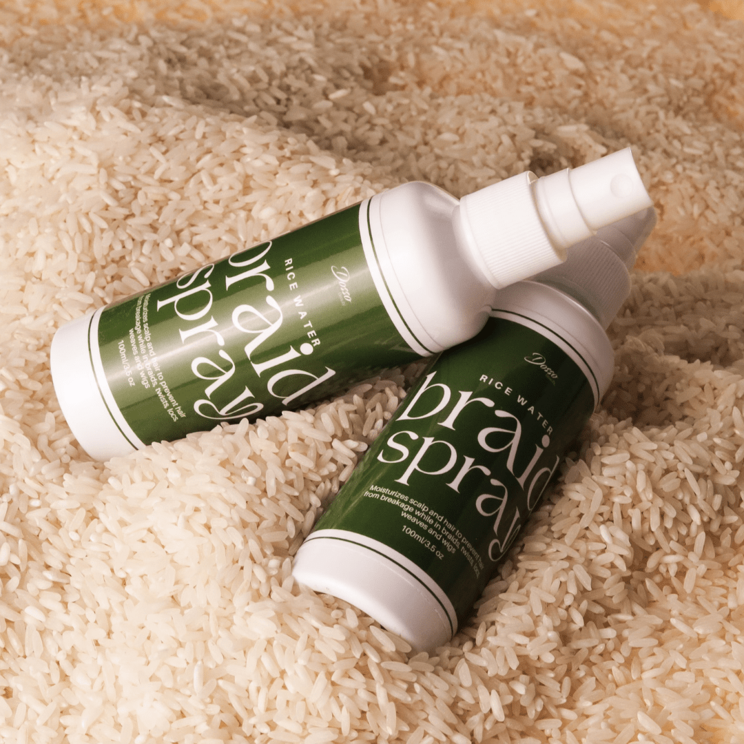 Rice Water Braid Spray bottles on rice, moisturizing and strengthening hair care for braids, twists, and locs.