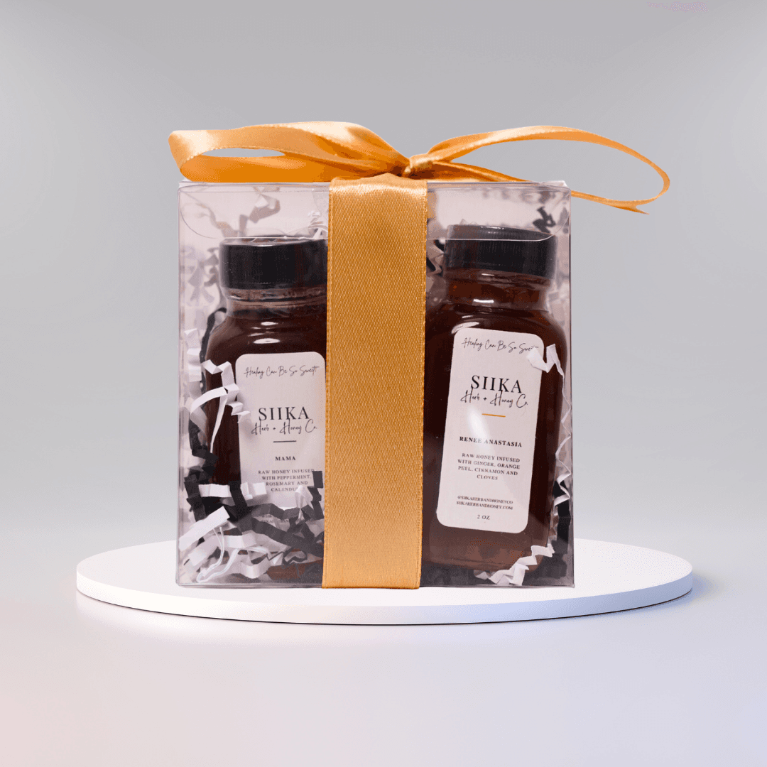 Infused Honey Discovery Set with two 2 oz jars wrapped in a clear box, perfect gift option with herbs and spices.